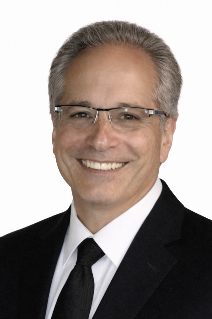 Professional headshot of a male chiropractor in his 50s to 60s, white medical coat, warm confident smile, short dark graying hair, neutral clinic background, soft studio lighting, authoritative yet approachable, photorealistic portrait photography